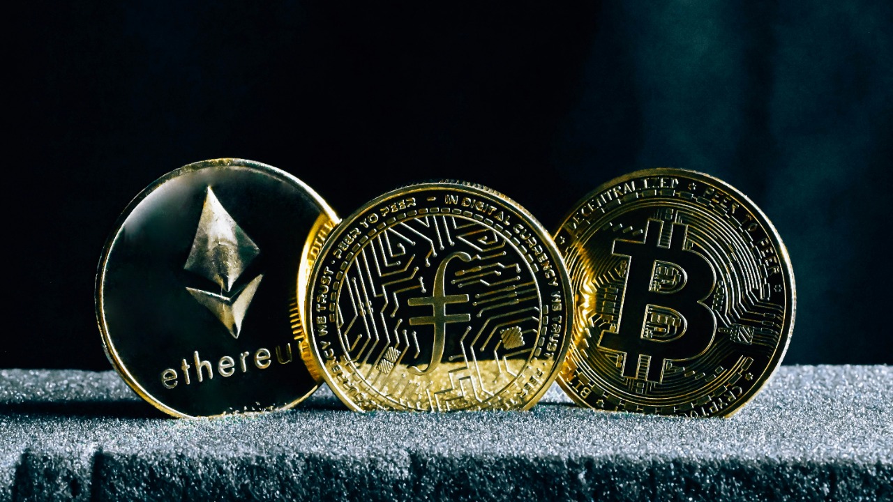 Image Credit: three bitcoins sitting on top of a table — Traxer