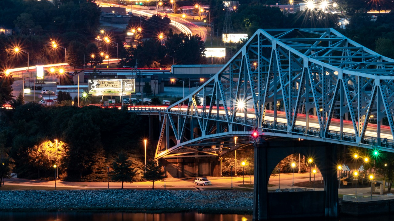 Image Credit: a bridge over a body of water at night — Brady Jordan