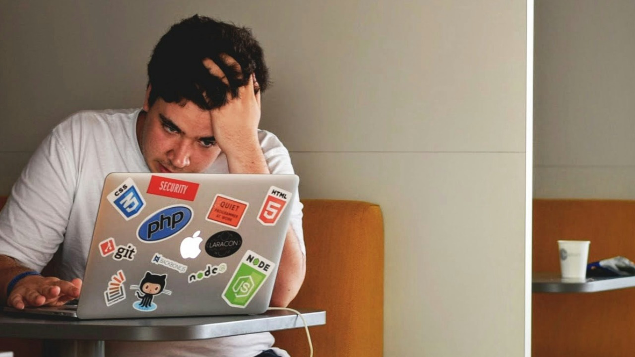 Image Credit: man wearing white top using MacBook — Tim Gouw