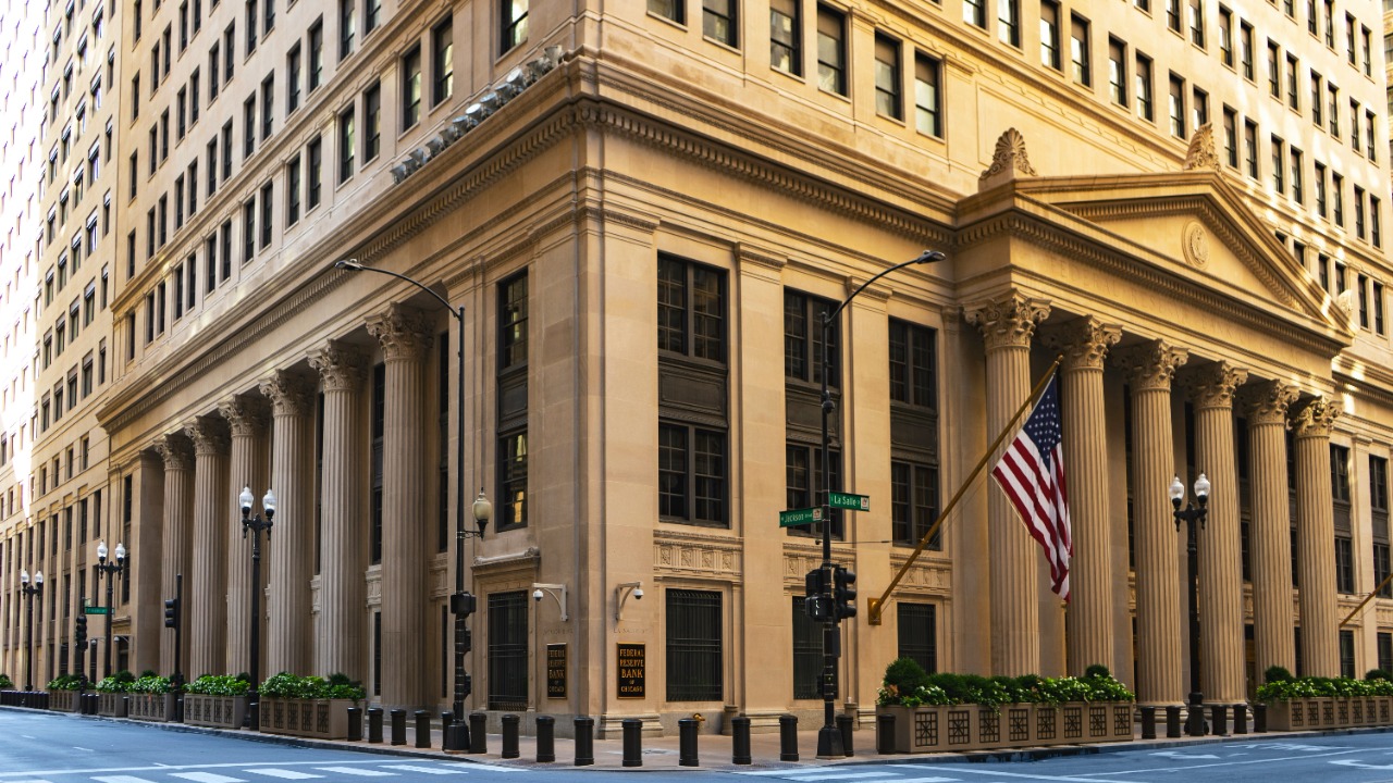 Image Credit: a large building with columns and a flag on the corner — Joshua Woroniecki