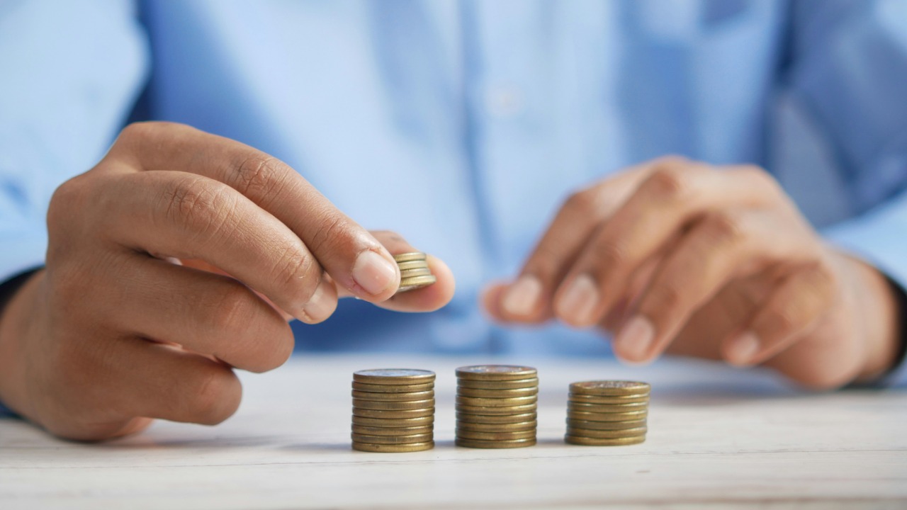 Image Credit: a person stacking coins on top of a table — Towfiqu barbhuiya