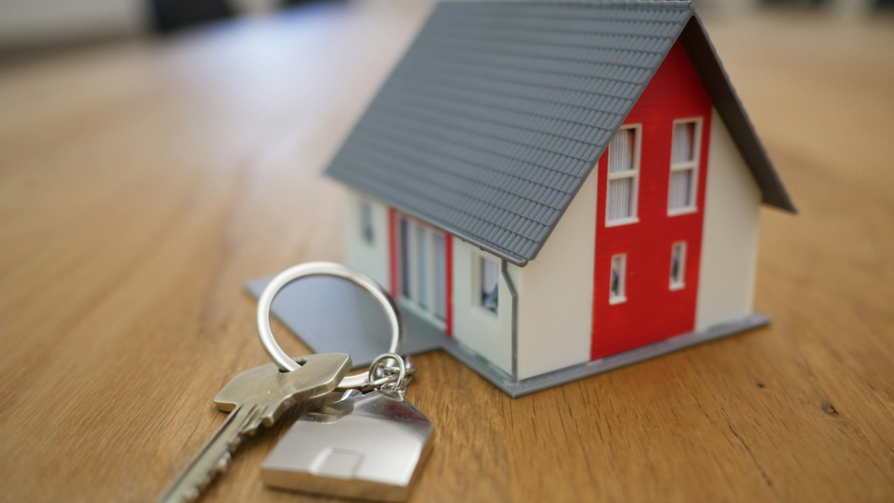 Image Credit: white and red wooden house miniature on brown table — Tierra Mallorca