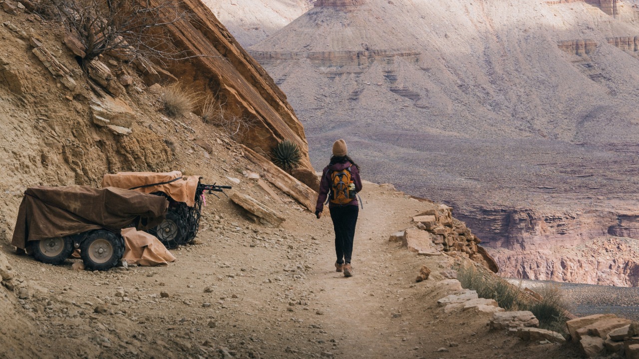 Image Credit: a person walking up a trail in the mountains — Chris Turgeon