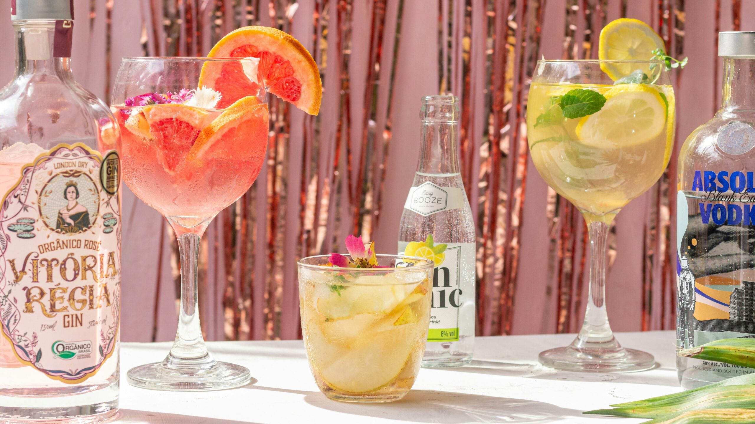 a table topped with glasses filled with different types of drinks