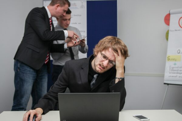 A man sitting in front of a laptop computer