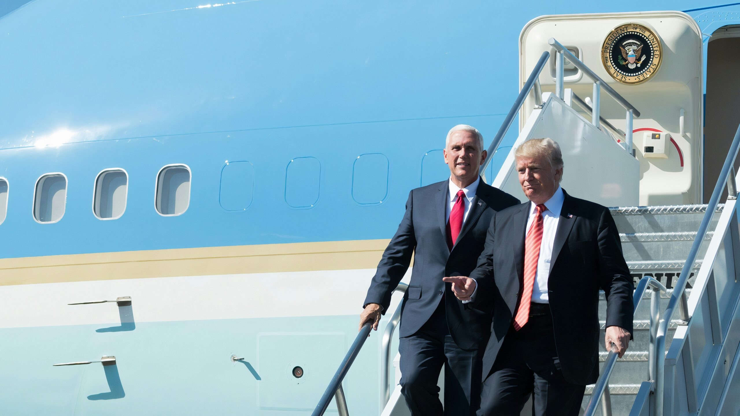 man in black suit standing beside woman in black coat