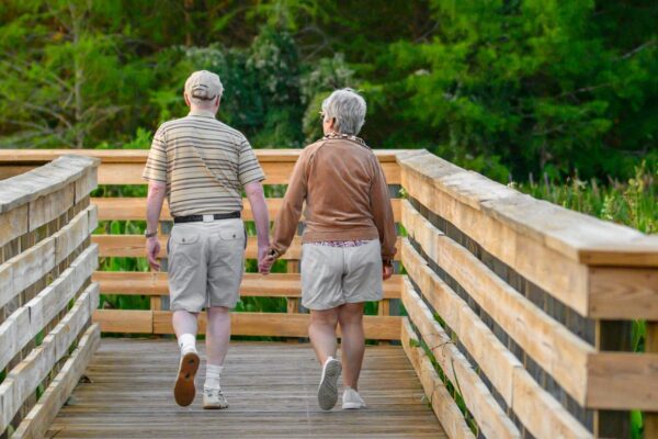 a couple of people that are walking across a bridge