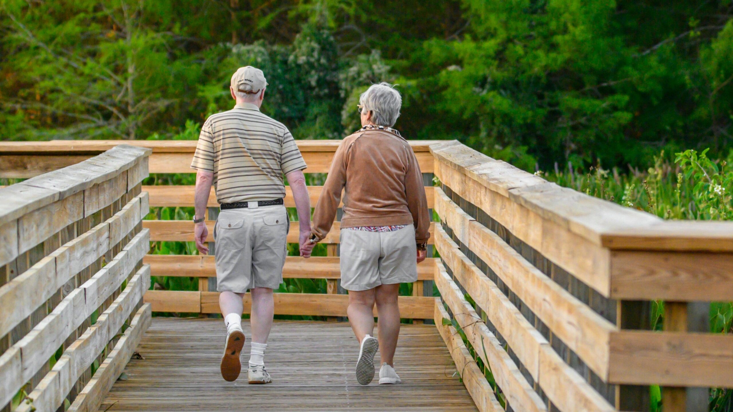 a couple of people that are walking across a bridge