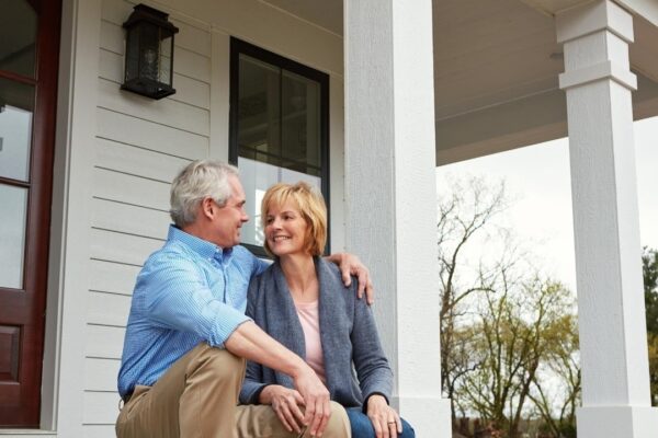 House outdoor and hug with senior couple with love real estate and happiness with relationship marriage and retirement Home front yard or old man with mature woman embrace and bonding together