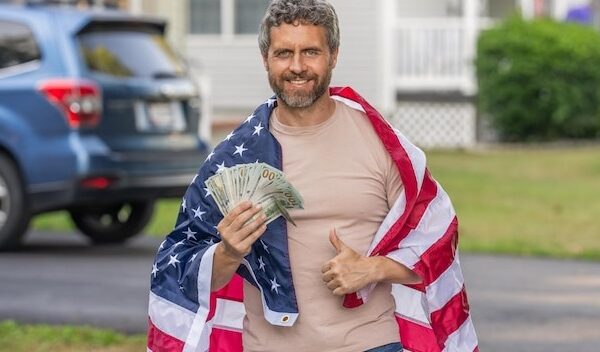 American tax policy Hispanic man and USA flag Paying tax in America Value added tax Taxation system Patriotic man Man with American flag and dollar money Inflation concept Thumb up