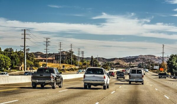Cars on road against sky in city