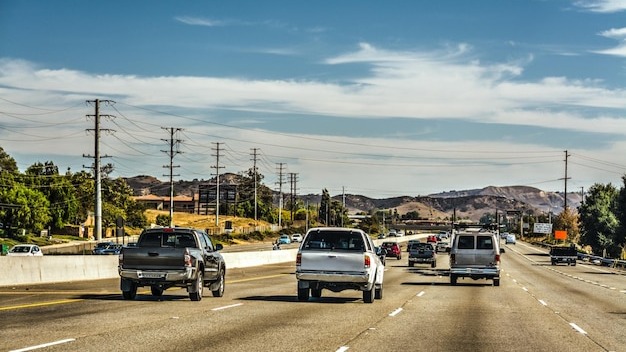 Cars on road against sky in city