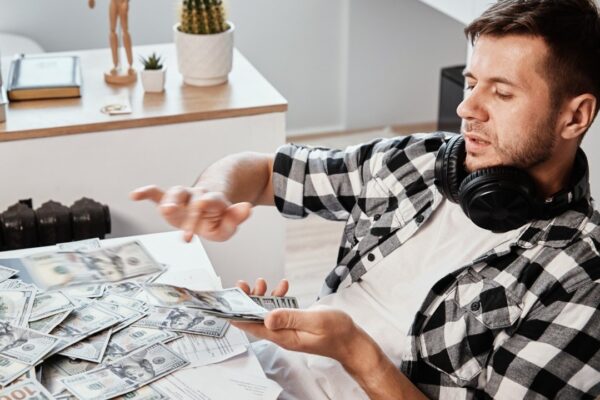Man counts dollar banknotes at home office