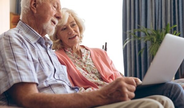 Couple interacting with each other while using laptop