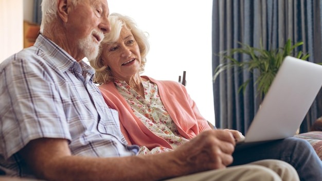 Couple interacting with each other while using laptop