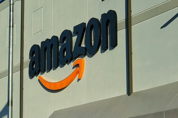 an amazon store with a person sitting in front of it