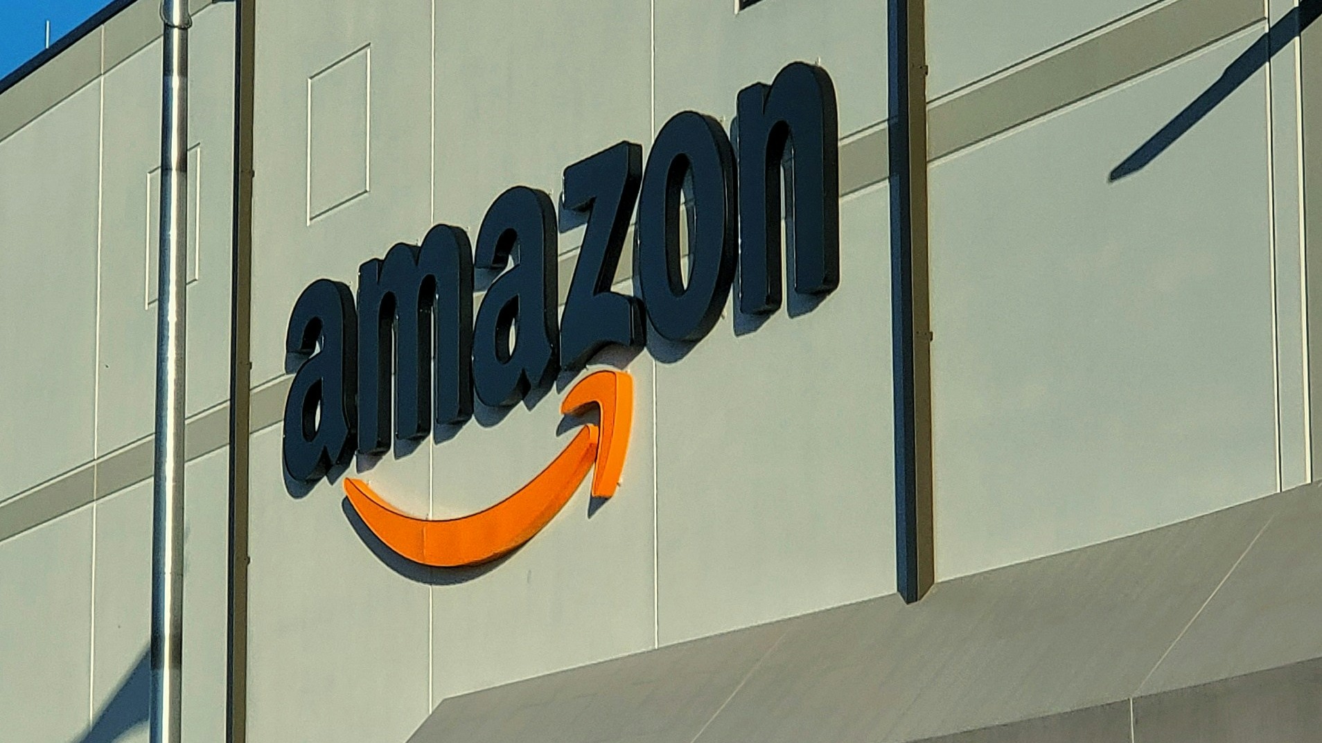 an amazon store with a person sitting in front of it