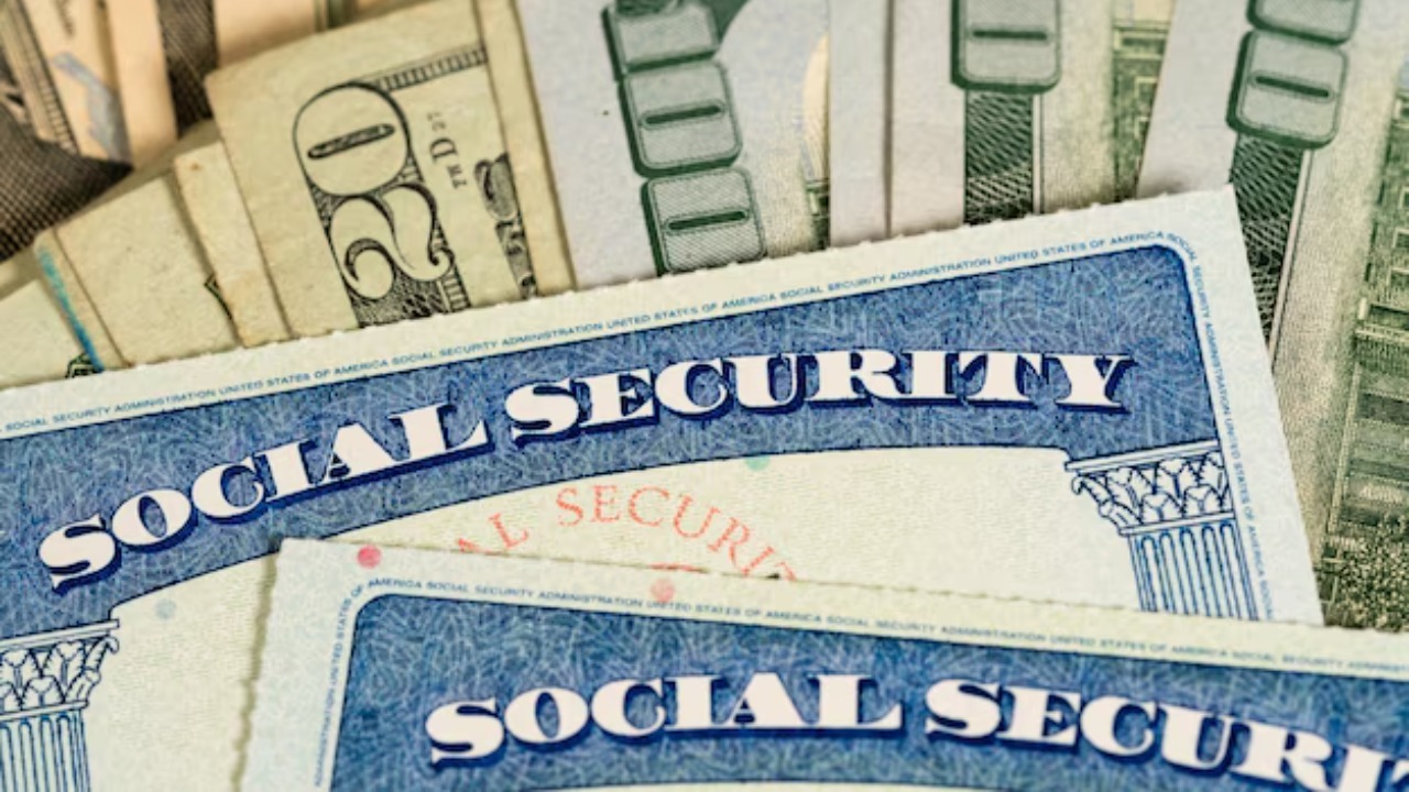 USA Social security cards laid on dollar bills