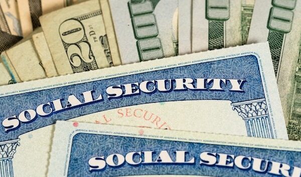 USA Social security cards laid on dollar bills
