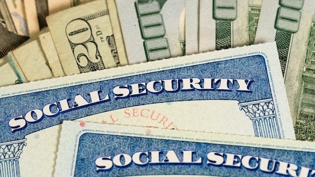 USA Social security cards laid on dollar bills