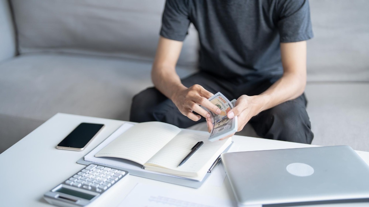 Man calculate money Banknotes finances savings economy home pay bills taxes financial at home