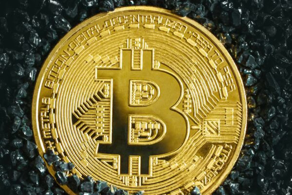 a bitcoin is shown on a black surface