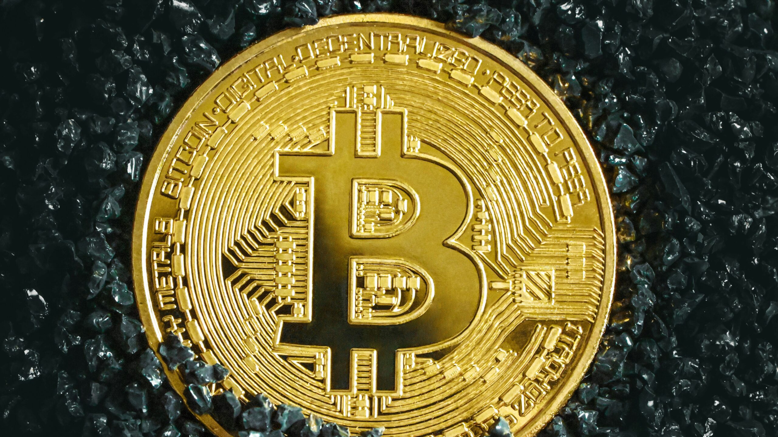 a bitcoin is shown on a black surface
