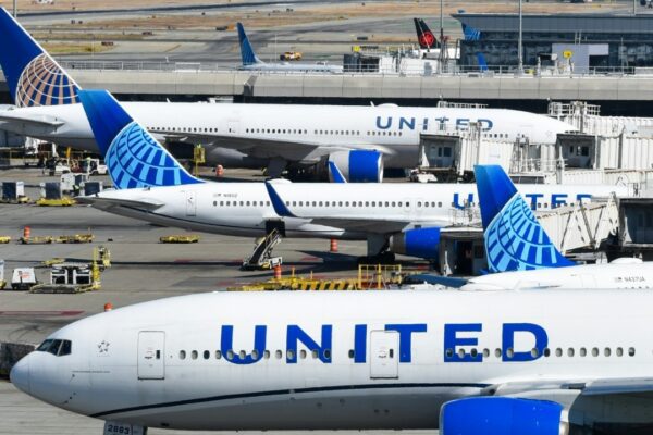 A bunch of airplanes that are on a runway