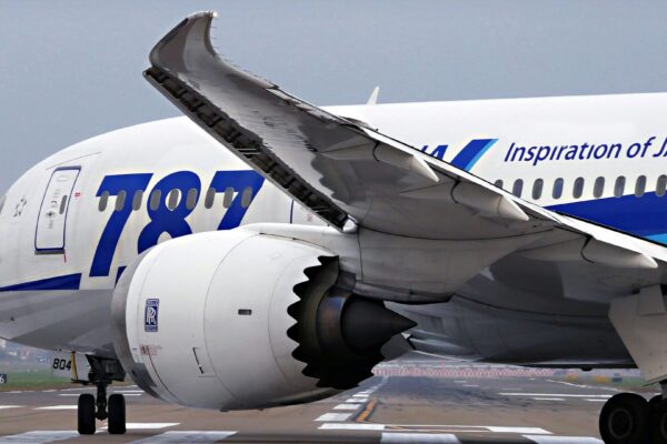 a large jetliner sitting on top of an airport runway