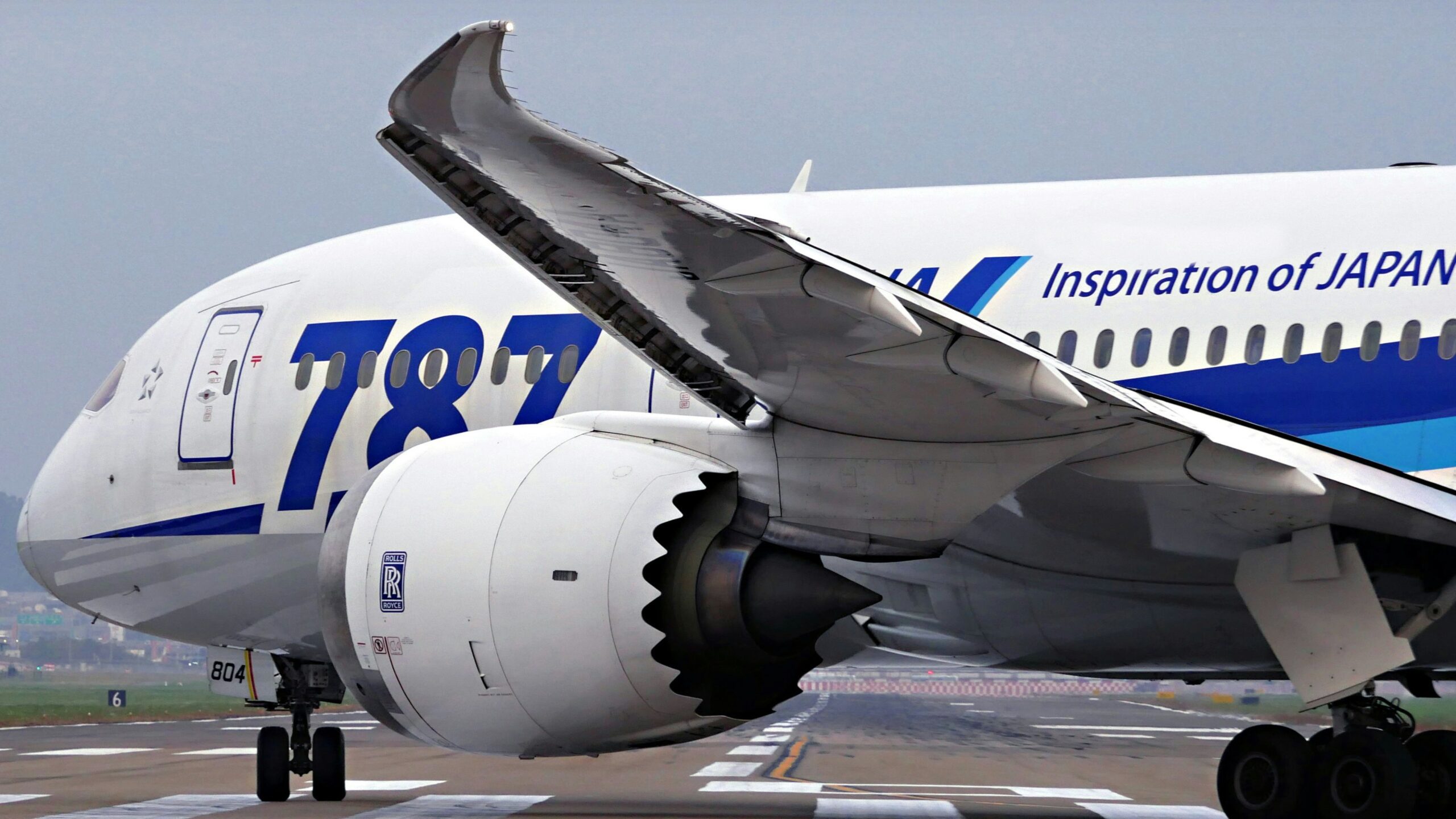 a large jetliner sitting on top of an airport runway
