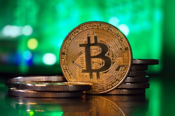 a bit coin sitting on top of a stack of coins