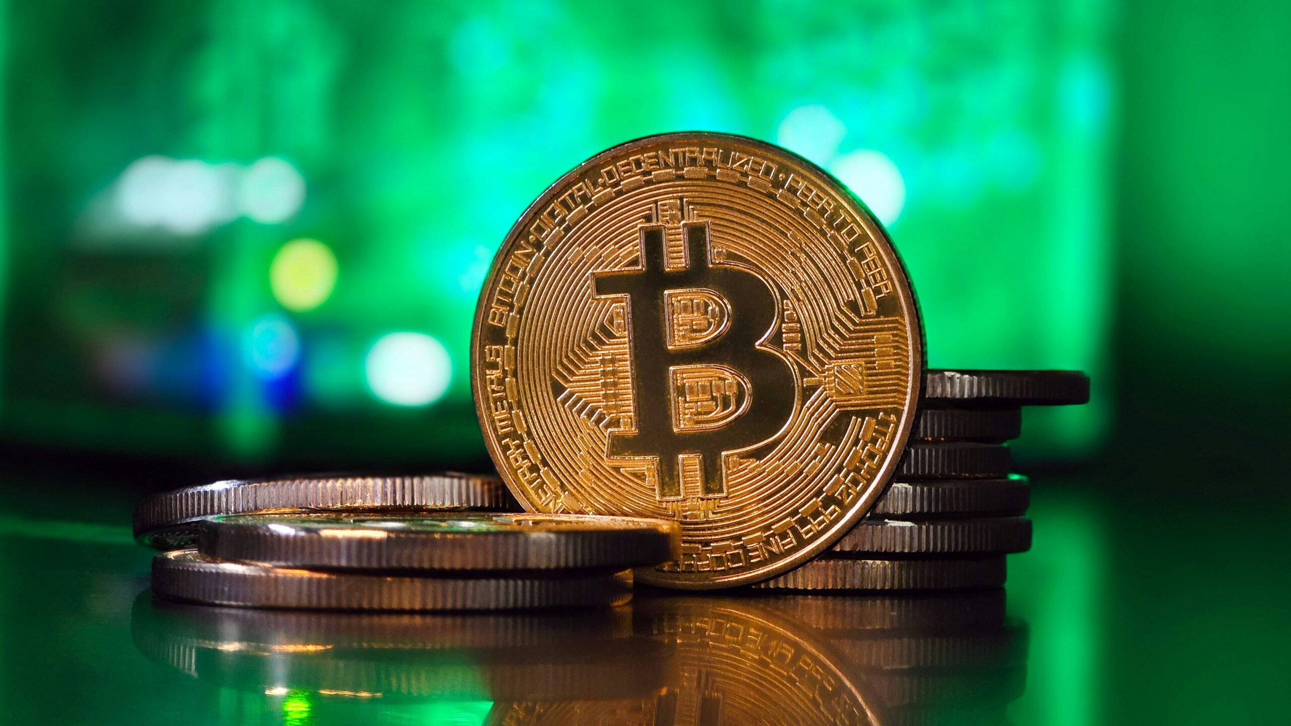 a bit coin sitting on top of a stack of coins