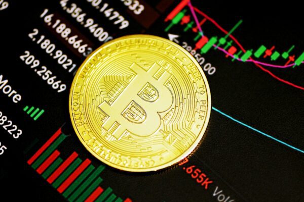 gold round coin on black surface