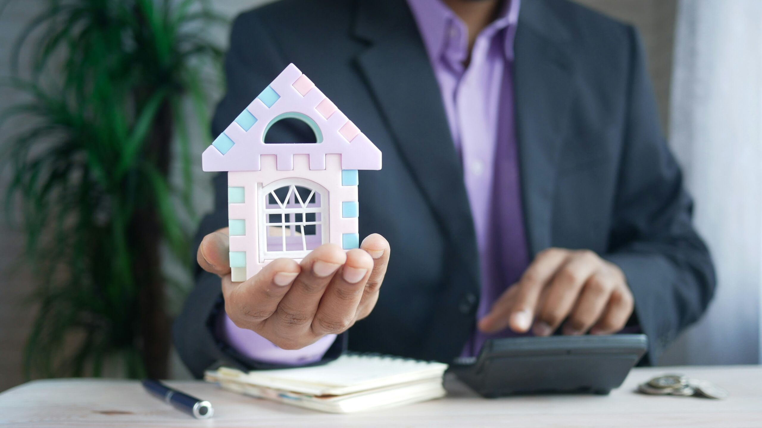 man in purple suit jacket using laptop computer