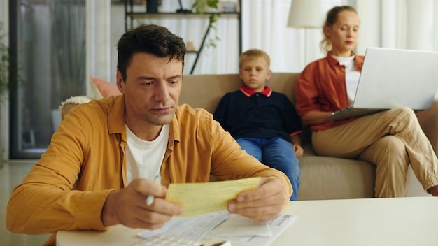 Father calculating family bills at home