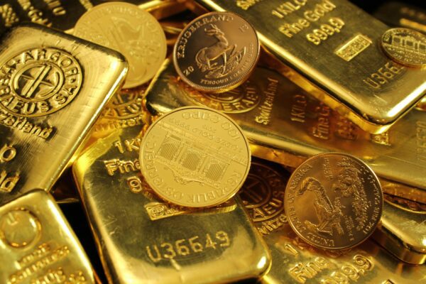 Detailed close-up of gold bars and coins, symbolizing wealth and investment. Perfect for financial imagery.