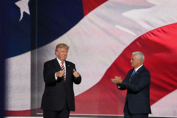 Donald Trump beside man in black suit