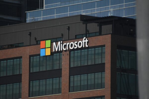 A tall building with a microsoft logo on top of it