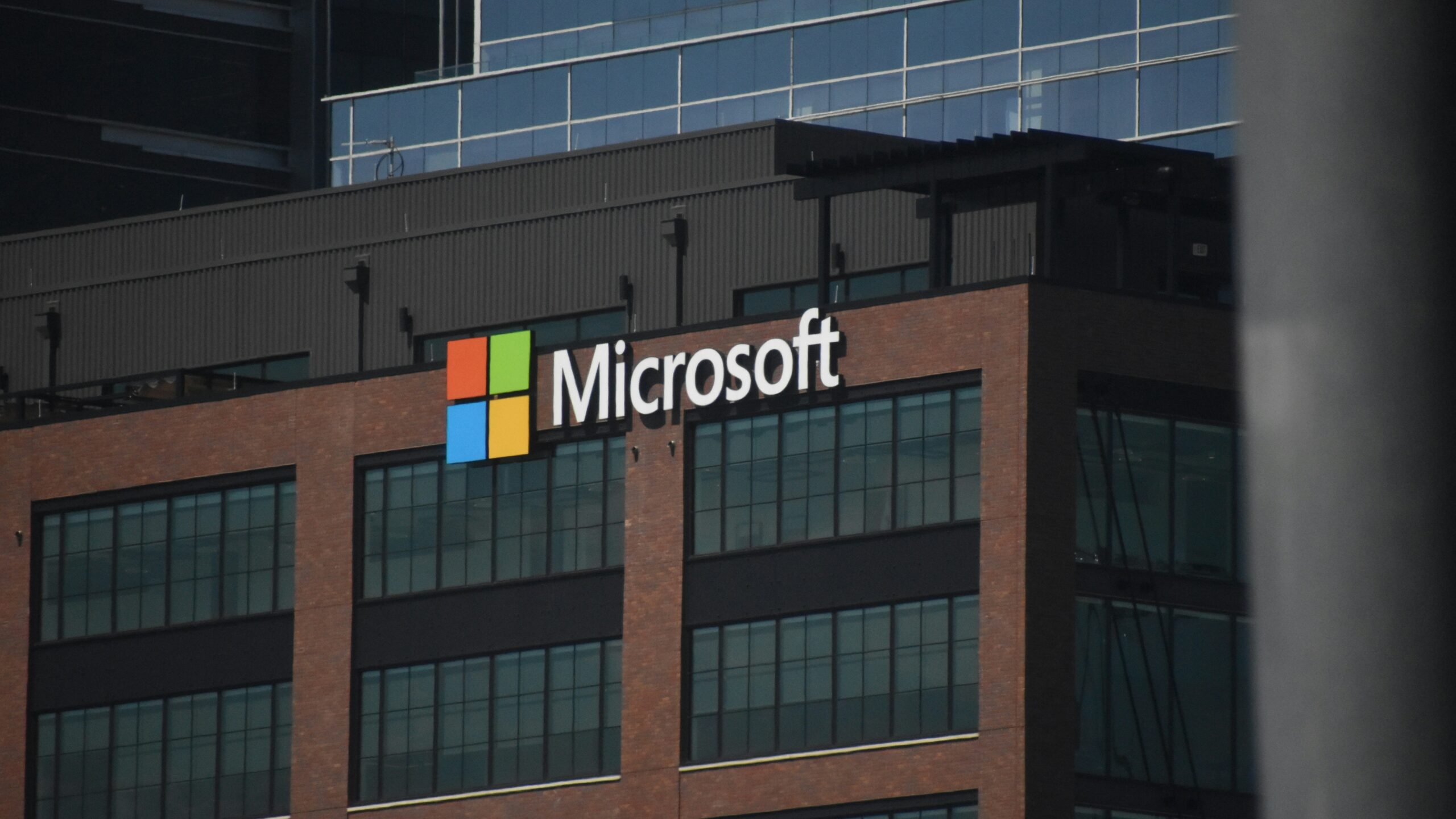 A tall building with a microsoft logo on top of it