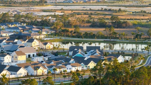 Unfinished frames of inexpensive homes with wooden roof beams under construction Development of residential housing in US suburbs Real estate market in the USA
