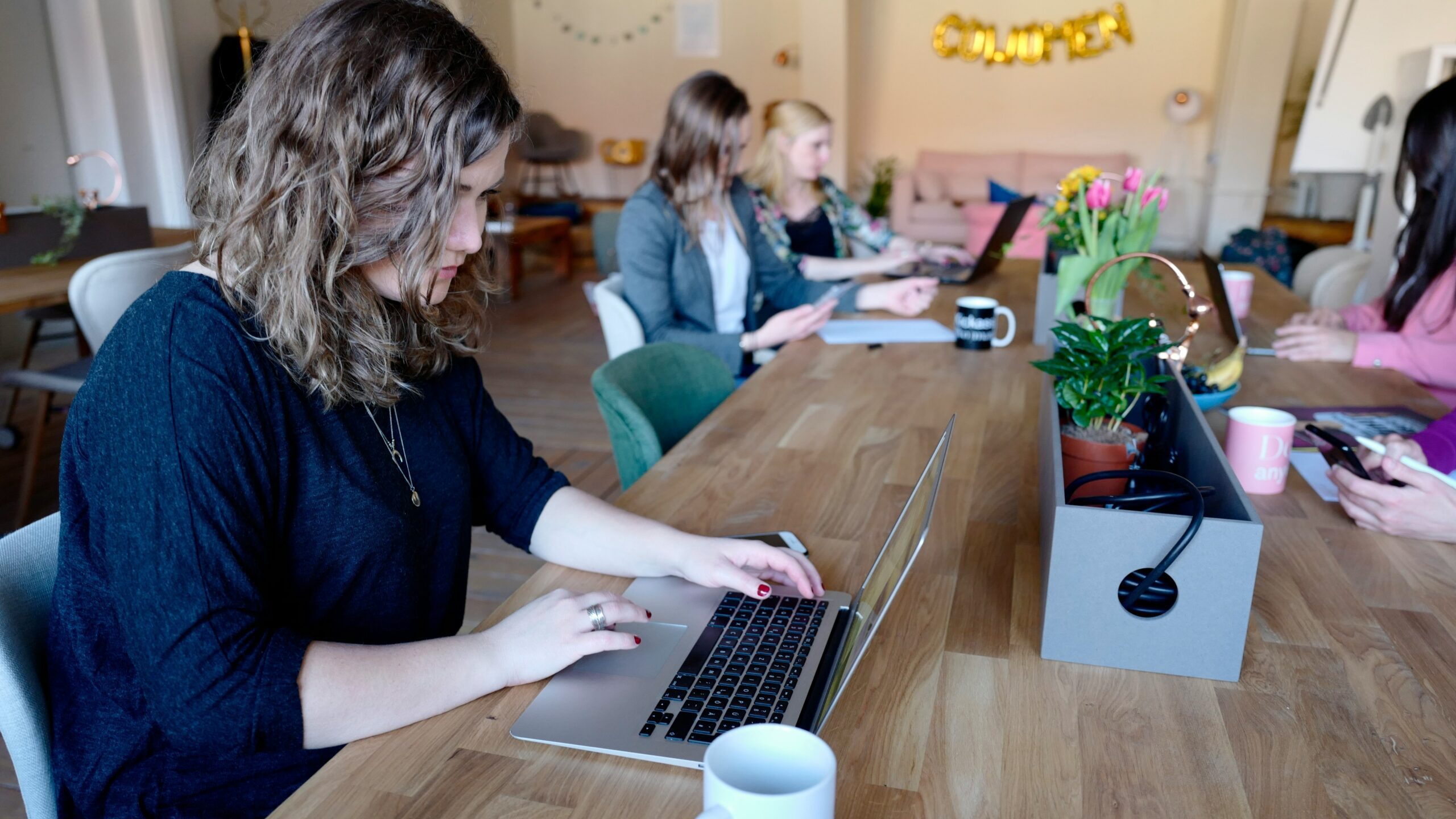 woman using MacBook in room