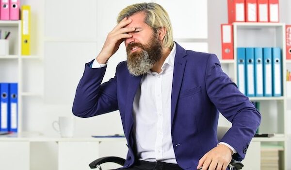 Job one of biggest stressors in life. Stress reduction mechanisms. Business man suffer headache. Businessman feel pain headache. Stressful life. Experience frequent headaches or migraine attacks.