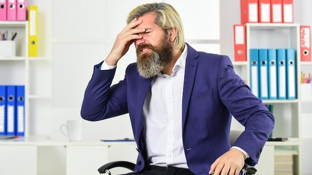 Job one of biggest stressors in life. Stress reduction mechanisms. Business man suffer headache. Businessman feel pain headache. Stressful life. Experience frequent headaches or migraine attacks.