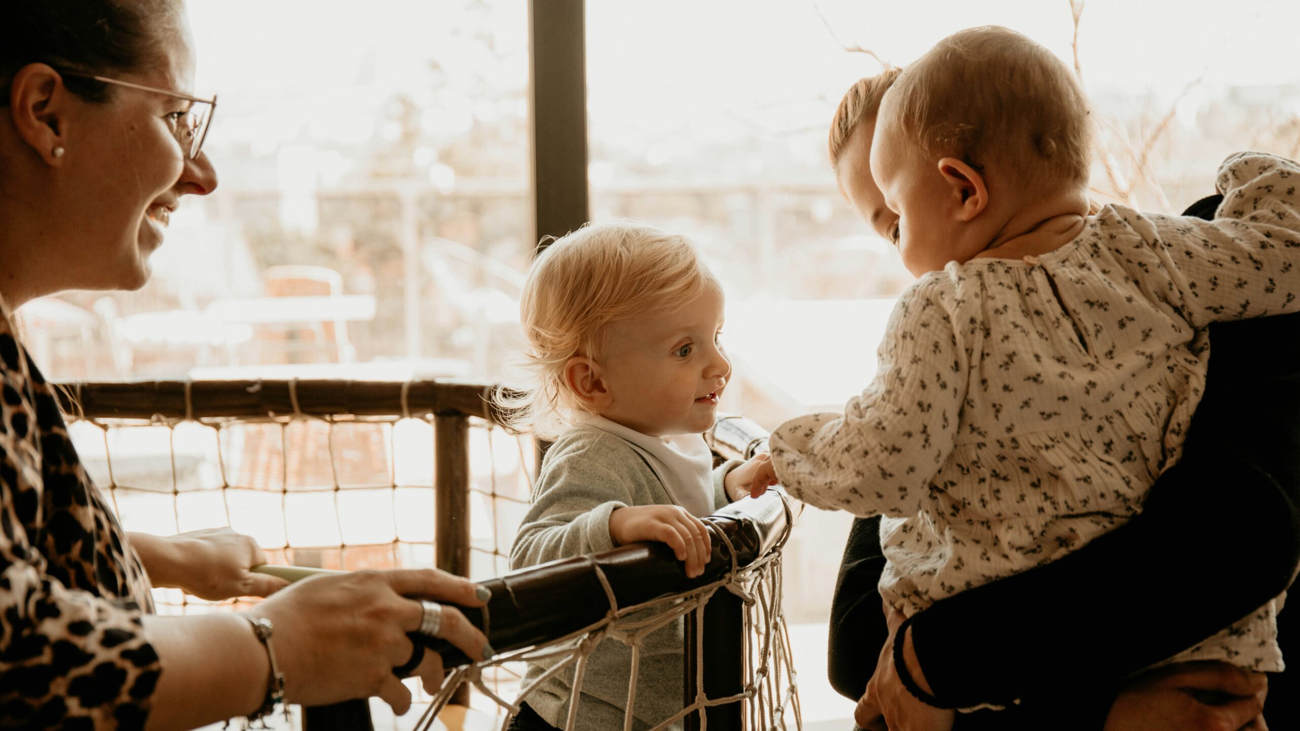 a woman and a child looking at a book