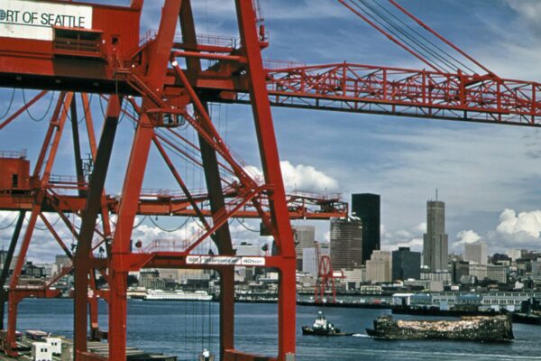 a large red crane sitting on top of a bridge