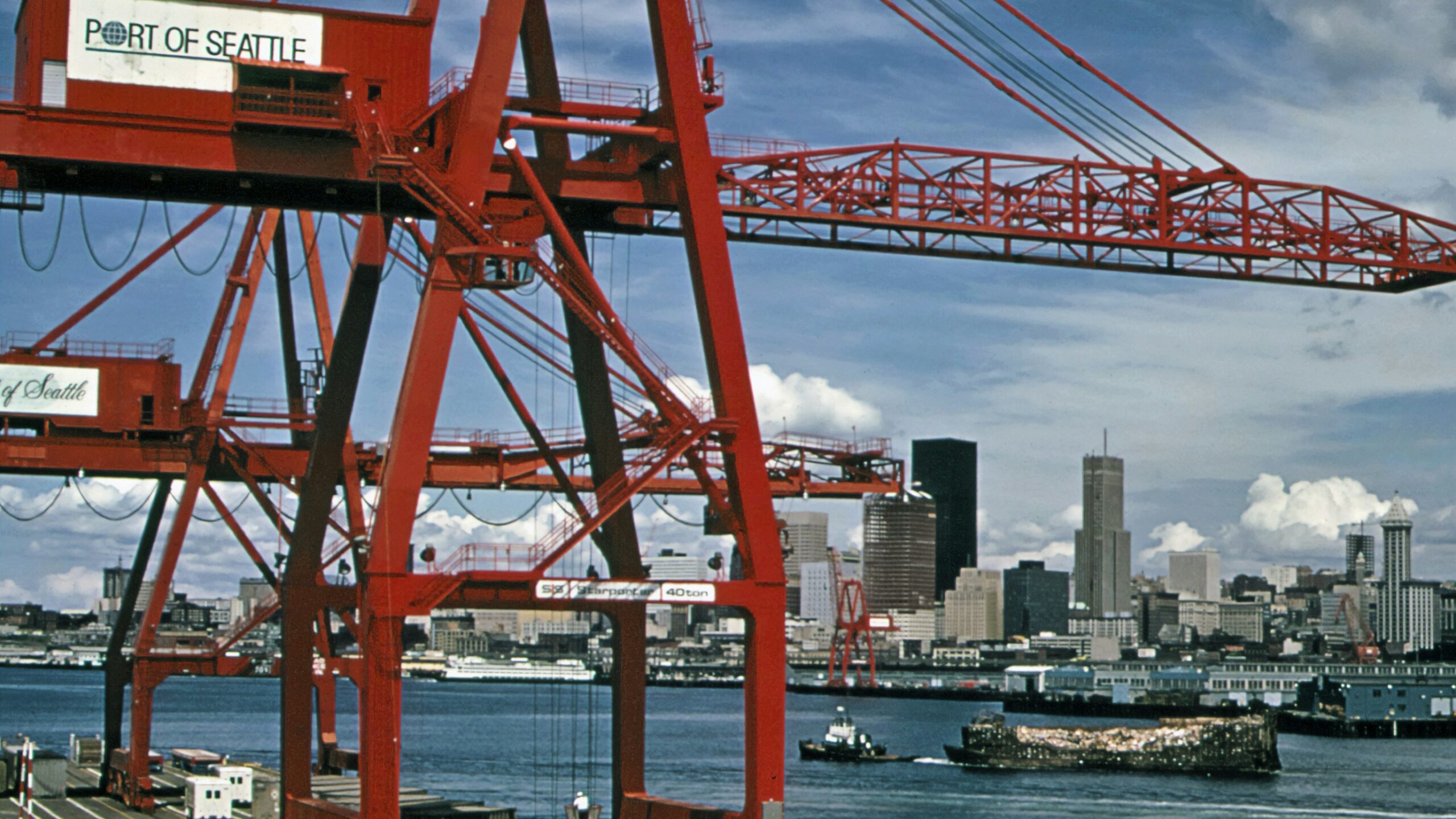 a large red crane sitting on top of a bridge