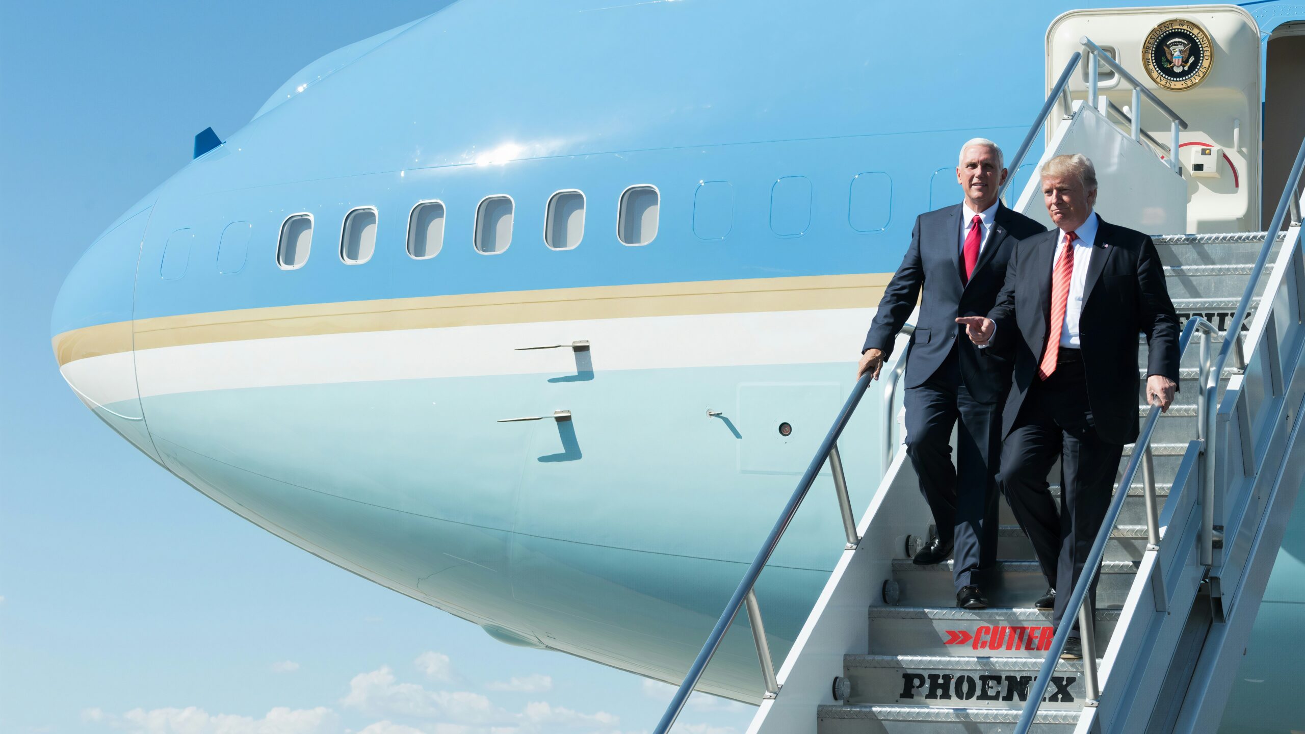 man in black suit standing beside woman in black coat