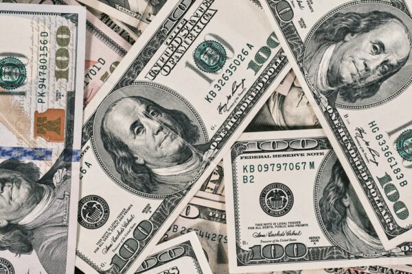 a pile of twenty dollar bills laying on top of each other