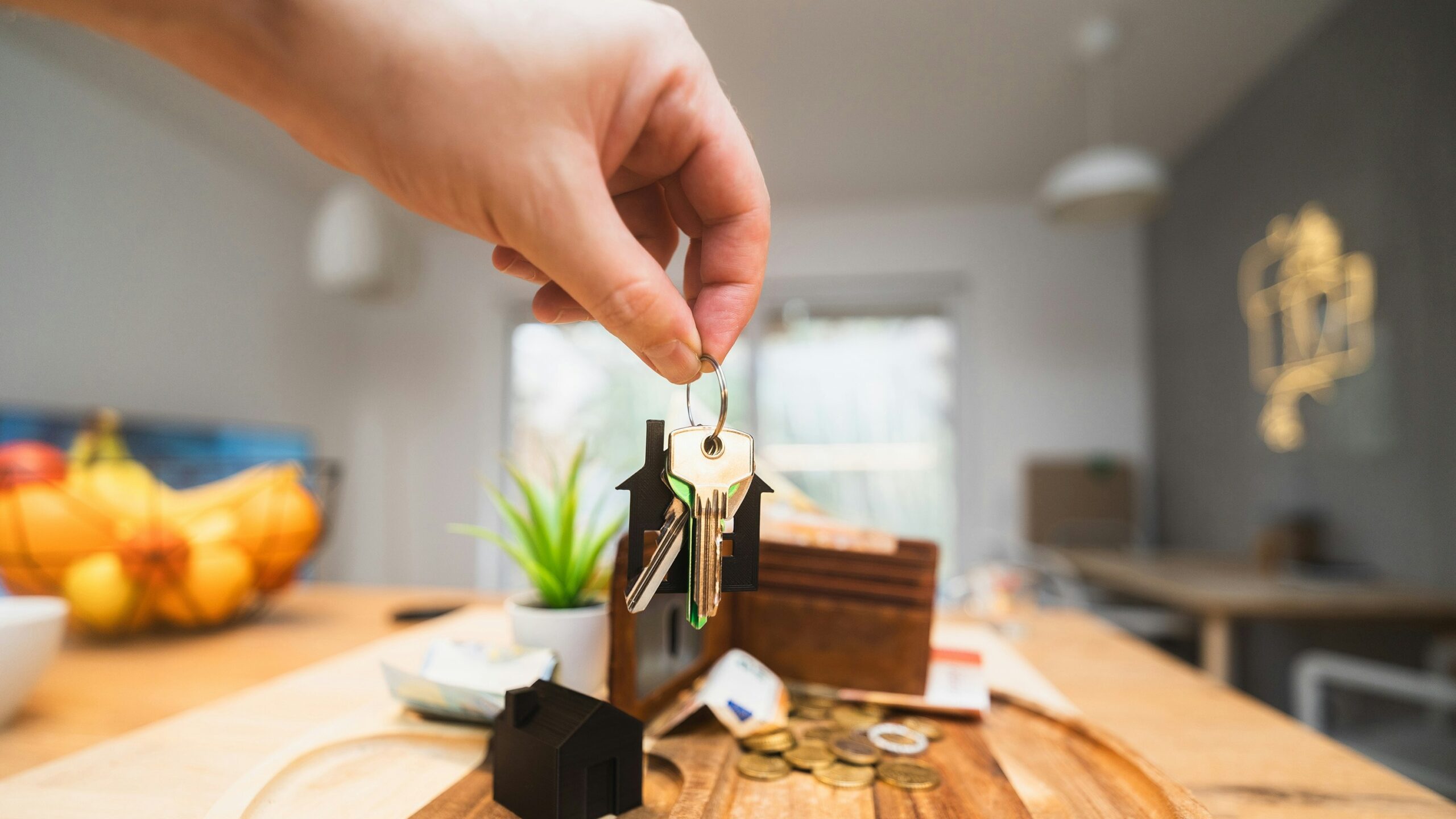 A person holding a piece of wood on top of a wooden table