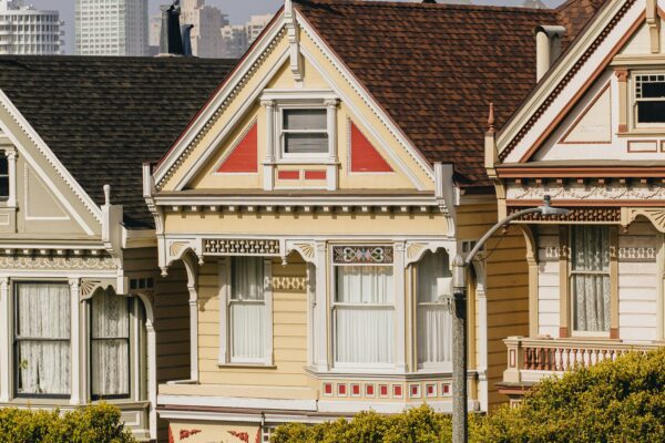 a row of houses with cars parked in front of them